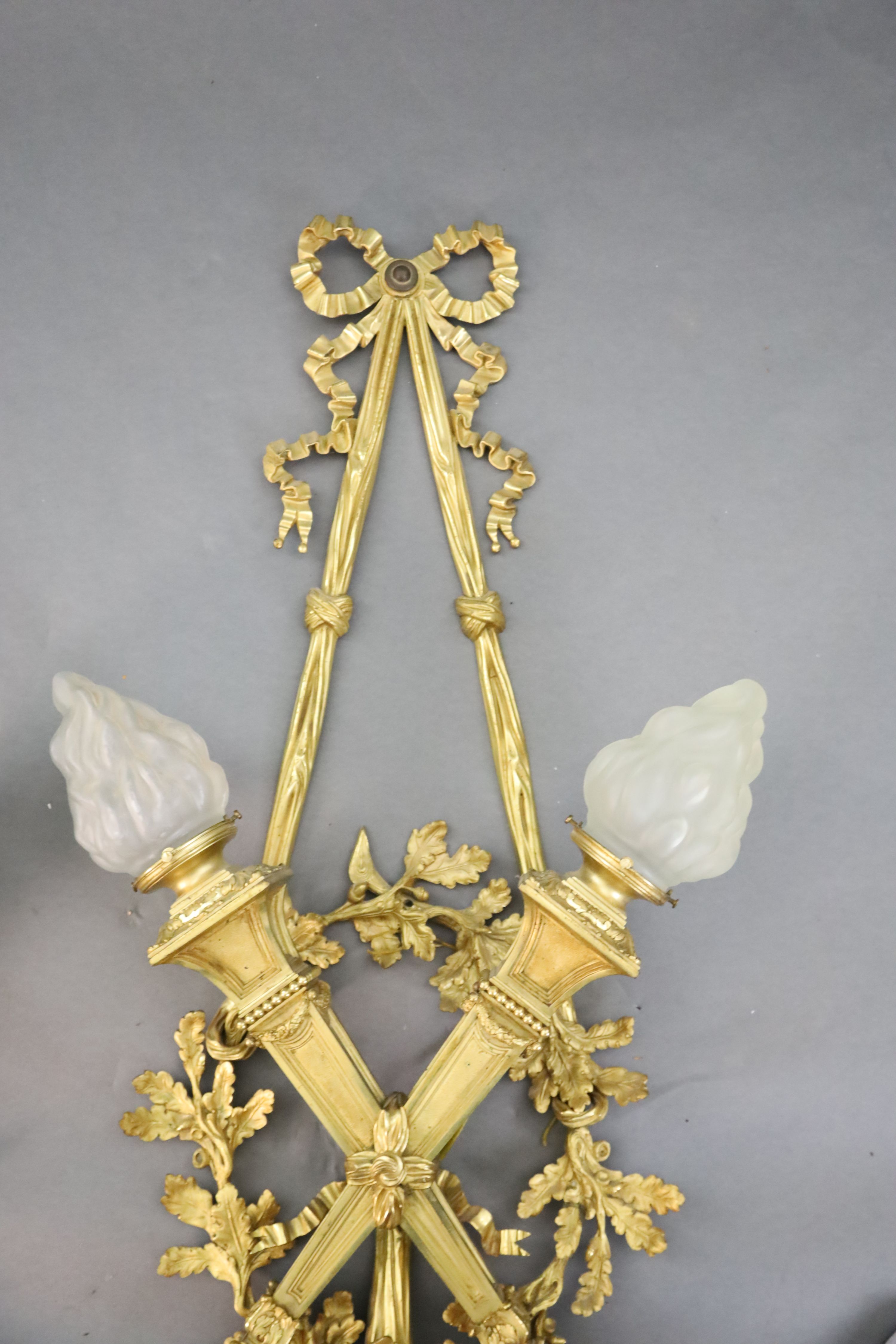 A pair of early 20th century Louis XVI style ormolu wall lights, width 1ft 10in. height 4ft 2in.